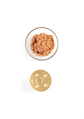 Jars of unopened cat food in a glass bowl. Style trend. Creative minimalistic layout. Flat lay 