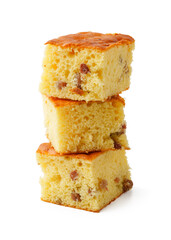 Delicious layers of moist cake squares stacked on a white background ready for dessert time