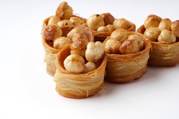Delicious traditional dessert filled with nuts showcased on a white background