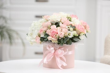 Beautiful bouquet in box on table at home