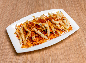 Deep fried Chinese Spicy noodle fish with spice salt served in tray dish isolated on wooden table side view of hong kong food