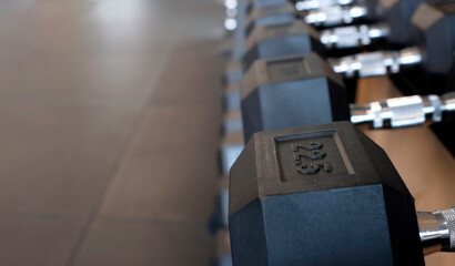 Selective focus on a row of weights in a gym