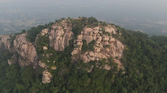 A sweeping shot that captures the vastness of Matha Forest, where towering trees and hilly terrain merge into a stunning mosaic of shades of green, stretching as far as the eye can see.


