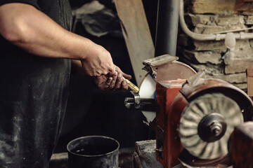 Polishing metal tool on abrasive wheel