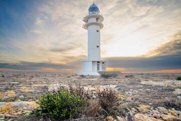 Formentera, baleares, faro Cap de Barbaria, cabo de Barbaria al atardecer  con el cielo rojo