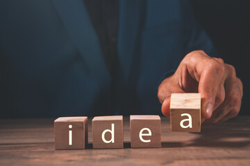 businessman holding letter block word