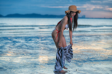 Portrait woman  in bikini on the beach with Sunset