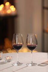 Glasses of wine for romantic dinner on table in restaurant