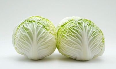 Fototapeta premium Two white cabbage heads are on a white background