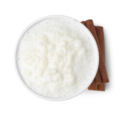 Delicious rice pudding with cinnamon sticks isolated on white, top view