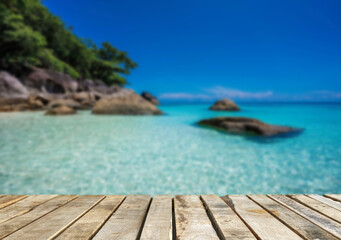 Obraz premium Wooden table top on the beach or sea.Party on the beach sunset time concept.For montage product display or design key visual layout.View of copy space.