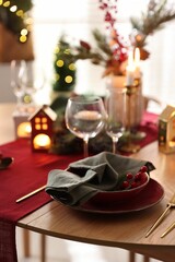 Christmas table setting with stylish dishware and festive decor indoors