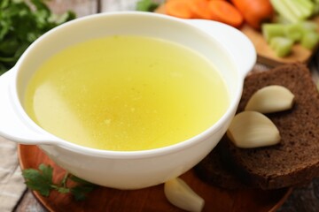 Tasty chicken bouillon served on table, closeup