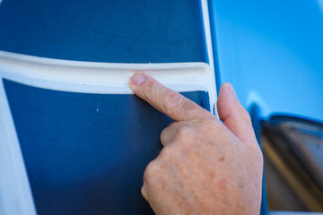 Applying silicon on caravan body