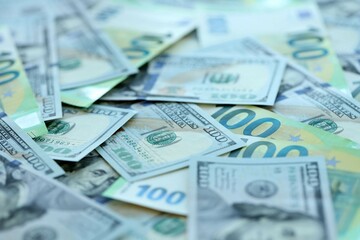 Big pile of Euro and USD banknotes. Many european and united states dollars