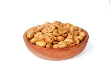 Roasted salted peanut on a wooden plate isolated on white background
