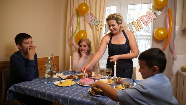 A cake with a candle for 41 years is served to the table. Birthday celebration.