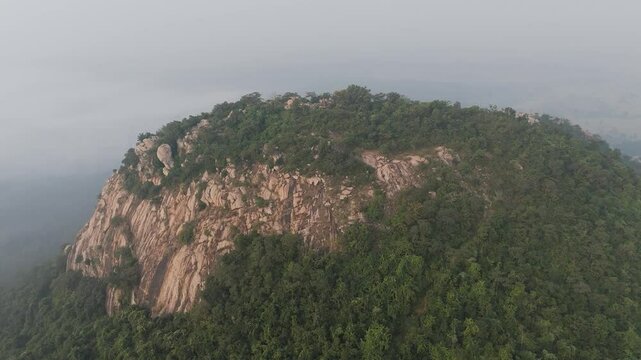 A peaceful shot of the hilltop with Matha Valley below, mist swirling around the peaks.