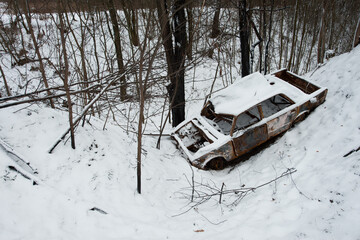Accident on a winter snowy track. car skidding and falling into a ditch due to ice. Safety and poor...