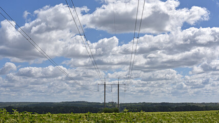 High voltage power line on blue sky background in Sunny day. wires, problems with electricity, power transmission. power line construction of cable supports and insulators. blackout, crisis
