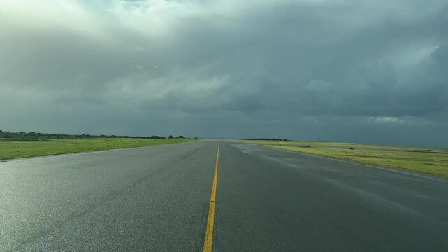 Exclusive pilot&rsquo;s FPV point of view from inside an airplane cokpit taxiing along an airport taxiway for departure under a stormy sky after a rainfall. 4K 60FPS