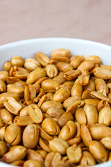 Close up of Roasted salted peanut on a white bowl