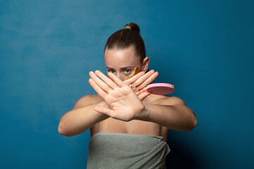 covering face with hand and putting other hand up front to stop camera, refusing photos or pictures