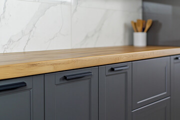 Modern kitchen countertop with gray cabinets and utensils