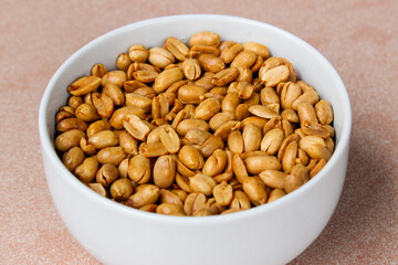 Close up of Roasted salted peanut on a white bowl