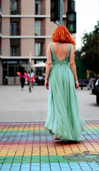 Fototapeta premium beautiful redhead woman wearing long maxi cocktail dress