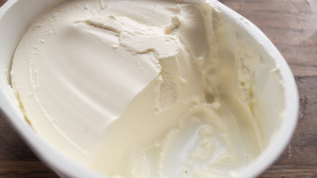 Close-up of cream cheese in a package. Texture of white cream cheese