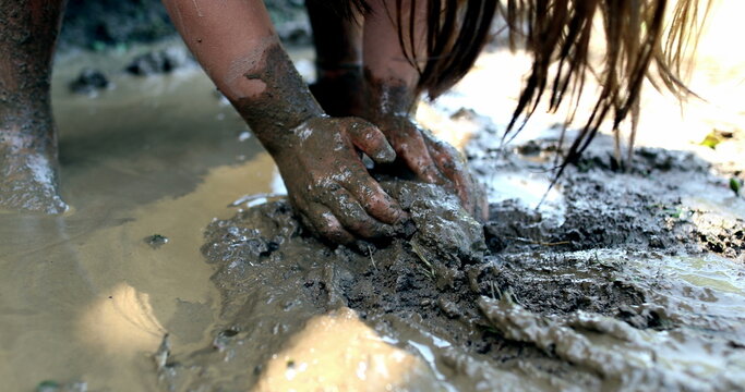 Child hands in mud. childhood moment kid hand in wet mud