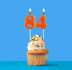 Orange birthday candle and cupcake - Number 84