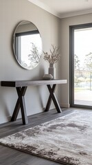 Minimalist entryway with dark wood console and bold circular mirror