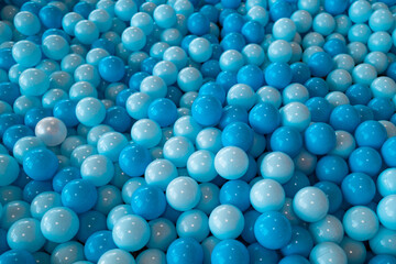 Blue ball. Close up of plastic balls in a kids ball pool. Kids playground. Recreation and entertainment concept. Colorful kid blue ball. Colorful blue ball at the playground.