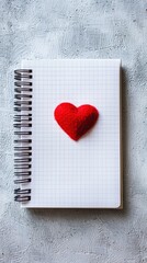 Minimalist notepad with heart sticker on textured white surface