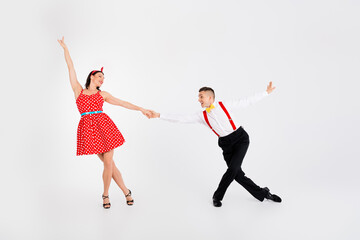 Full length photo of two young people hold arms dancing performance isolated on white color...