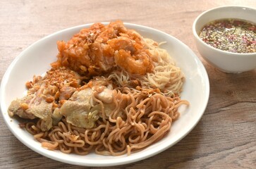 slice boiled and fried chicken dressing instant noodles and rice vermicelli topping garlic on plate dipping spicy seafood sauce