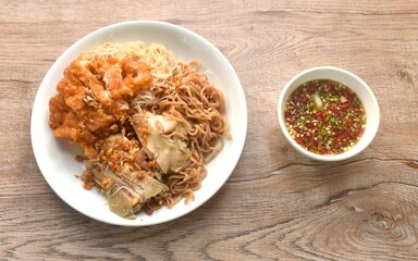 slice boiled and fried chicken dressing instant noodles and rice vermicelli topping garlic on plate dipping spicy seafood sauce