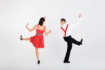 Photo of charming lovely positive couple ballroom dancers moves in cha cha dance isolated on white...