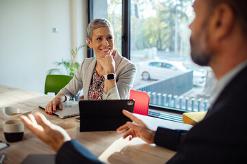 Business team brainstorming in modern office with natural light