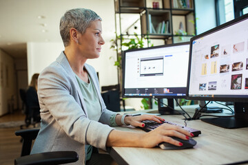 Focused businesswoman working on office computer