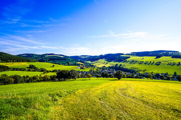 Fototapeta premium View of the green landscape near Oberhenneborn in the Sauerland. Hiking trails in nature. 