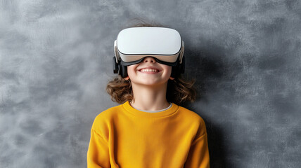 child wearing virtual reality headset smiles joyfully, engaged in immersive experience. bright yellow sweater contrasts with gray background, enhancing cheerful atmosphere