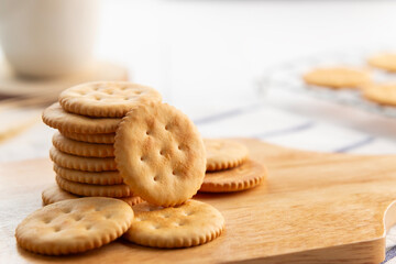 Dry thin circle crispy crackers on cutting board on wood table.with copy space.