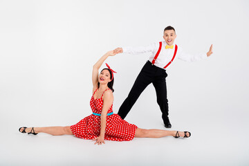 Photo of charming couple ballroom dancers samba choreography in dance studio isolated on white...