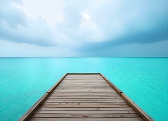 Fototapeta premium A wooden dock overlooking a calm turquoise ocean with a cloudy sky in the background