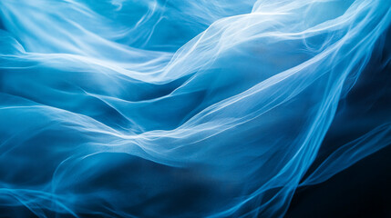 Obraz premium Ethereal blue fabric flowing gracefully in soft light at close range. 