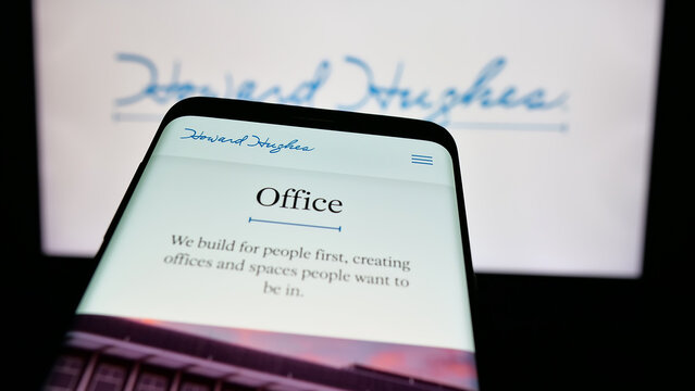 Stuttgart, Germany - 11-26-2024: Smartphone with website of US real estate company Howard Hughes Holdings Inc. on screen in front of logo. Focus on top-left of phone display.