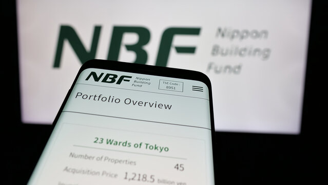 Stuttgart, Germany - 11-28-2024: Mobile phone with website of Japanese company Nippon Building Fund Inc. (NBF) on screen in front of logo. Focus on top-left of phone display.